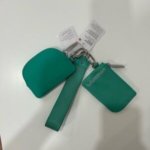 NEVER USED. TAGS STILL ATTACHED. Lululemon wristlet. Teal.